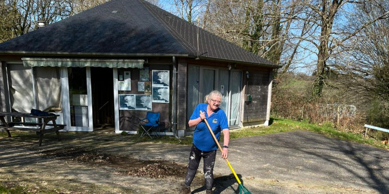 Raking leaves at the campsite
